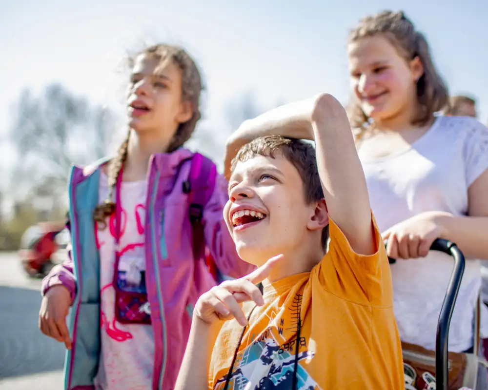 Eine inklusive Gruppe von Kindern in sommerlicher Kleidung.