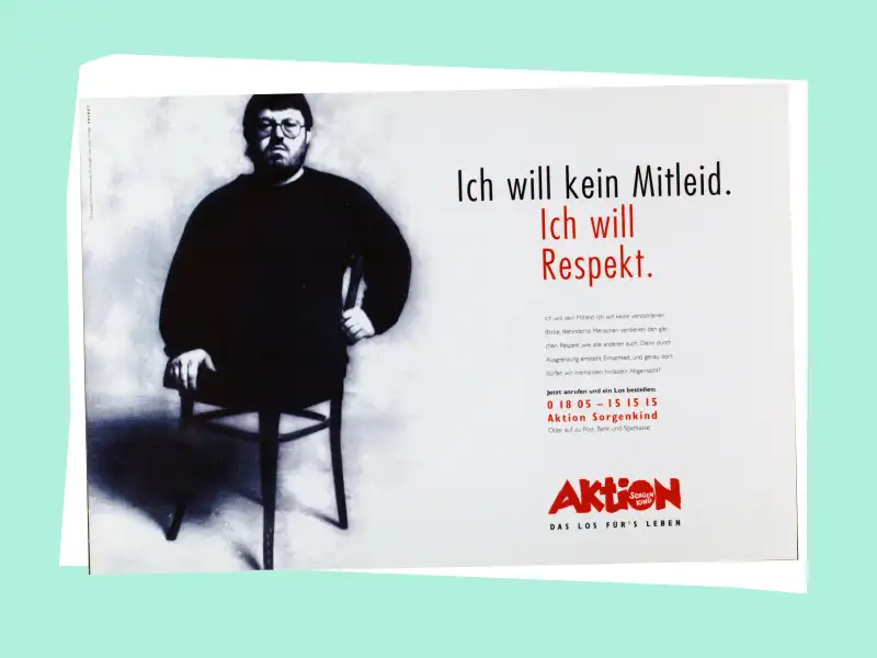 Ein Mann ohne Beine sitzt auf einem Stuhl. Neben ihm ist der Schriftzug "Ich will kein Mitleid. ich will Respekt." zu lesen.
