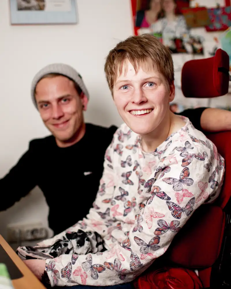 Ein Mann und eine Frau im Rollstuhl sitzen nebeneinander