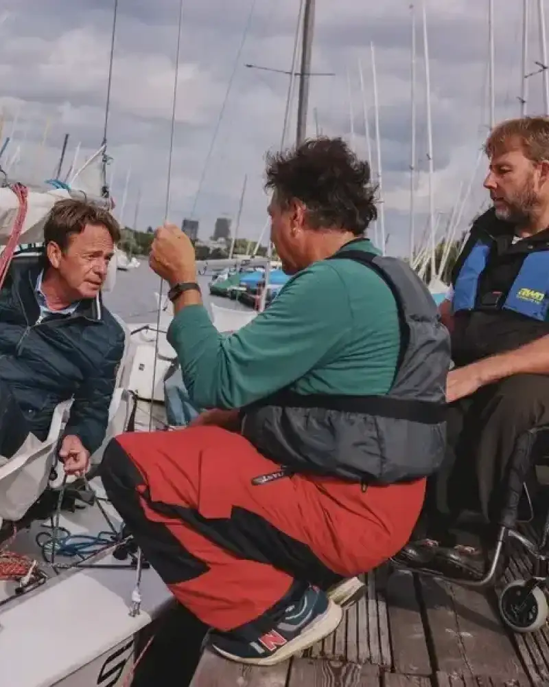 Drei Männer bei einemSegelboot