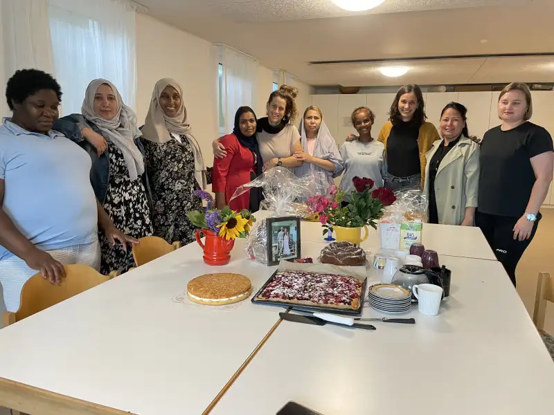 Mehrere Frauen stehen hinter einem Tisch mit Kuchen