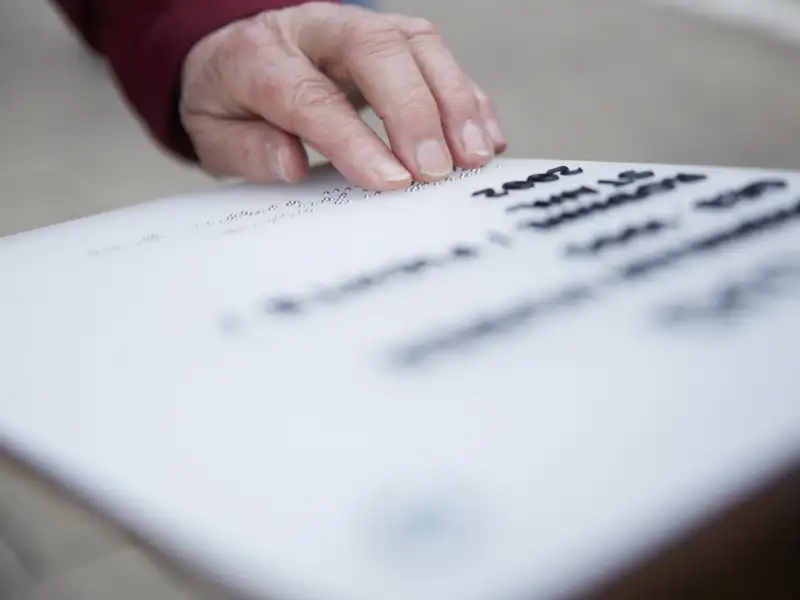 Eine Person liest Brailleschrift