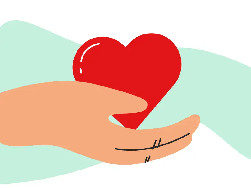 Eine Hand, die ein Herz hält.