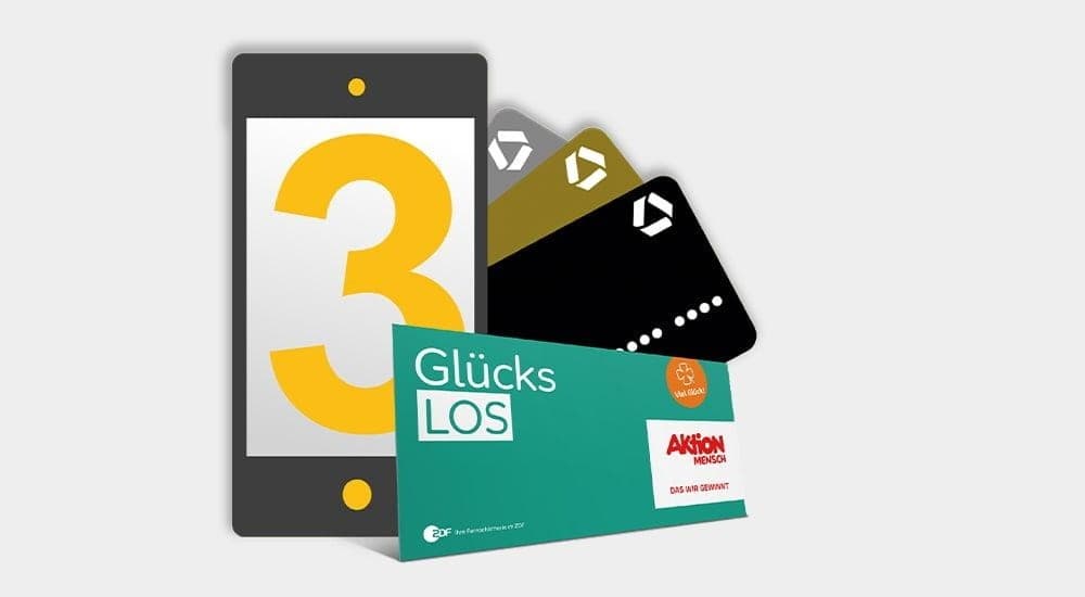 Die Commerzbank zeigt 3 Kreditkarten und ein Aktion Mensch Los.