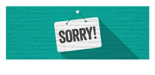 SORRY! Schild vor Steinmauer